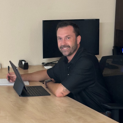 sean-yoder-sitting-at-desk-smiling