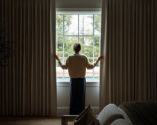 How Can Drapery Make a Large Window Wall Feel More Balanced?