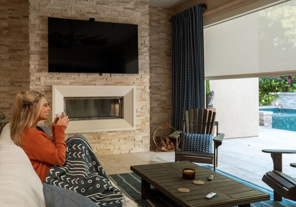 Outdoor shade and exterior drapes and in an enclosed patio.