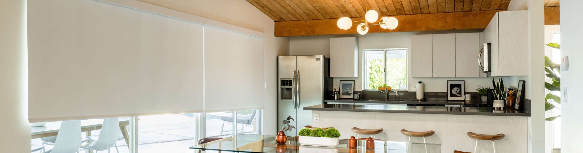 white roller shades over patio door in modern kitchen