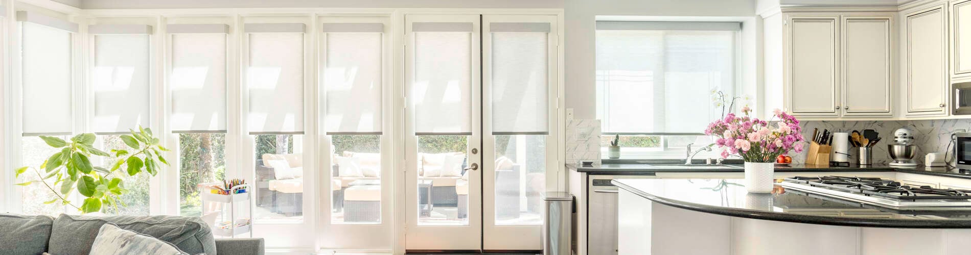 gray roller shades in living and kitchen area