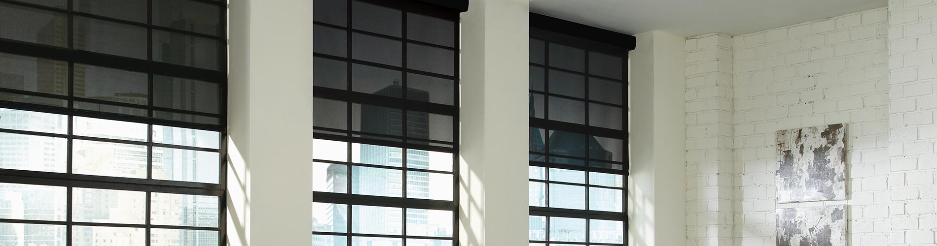 automated-black-roller-shades-living-room-desktop